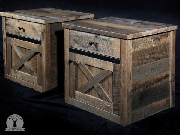 Rustic reclaimed barnwood end tables each with a barnwood top, drawer and a storage compartment behind a traditional X-style barndoor.