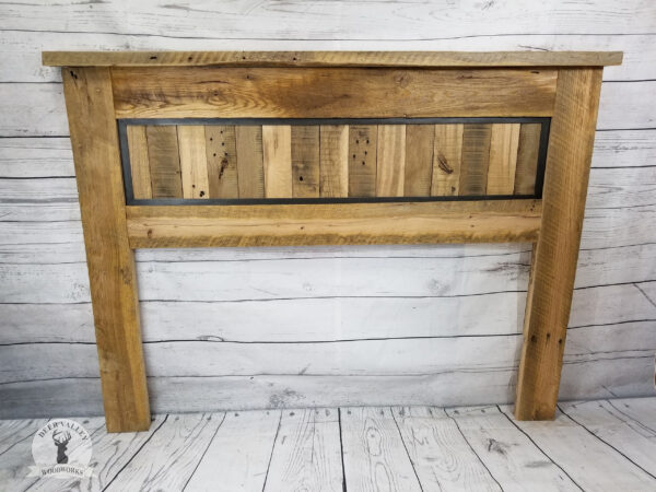Reclaimed barnwood headboard with vertical clapboards inset into an antiqued blackened metal frame.