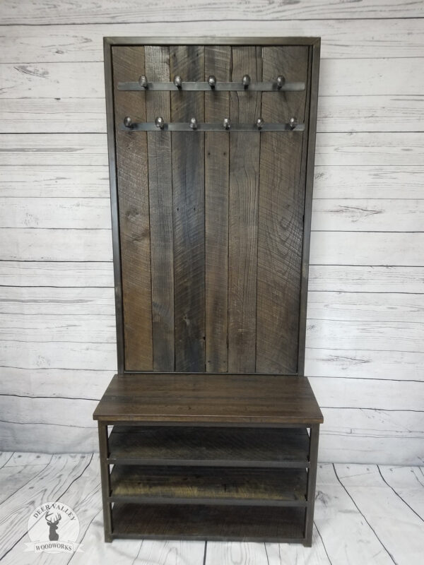 Authentic barnwood hall tree with blackened ebonized finish, three shoe shelves, barnwood bench seat, barnwood back with a double row of repurposed railroad spike coat hooks and a welded steel frame with an antiqued blackened finish.