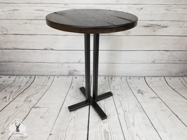 Rustic bistro table with thick round barnwood top with a True Black stain on a blackened welded steel tubing frame.