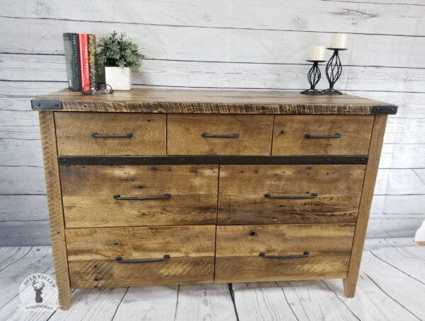 Reclaimed barnwood dresser with a large top, three shallow drawers, four wide drawers, blackened metal accents with corner brackets, divider strap and standard bar pulls.