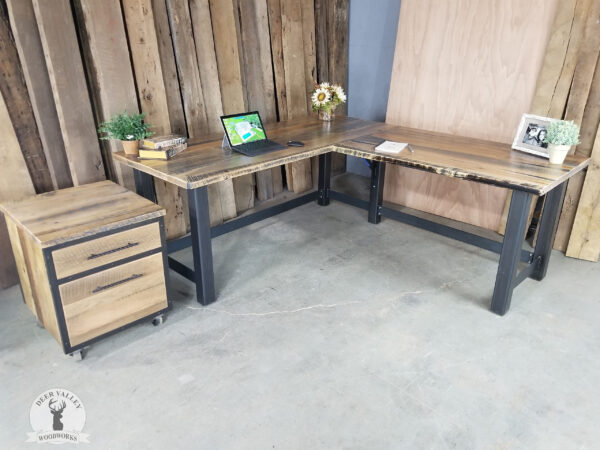 Rustic barnwood corner desk with a large desktop and antiqued blackened welded steel frame and legs along with an authentic barnwood rolling cart with a storage drawer and deep file drawer with antiqued blackened frame.