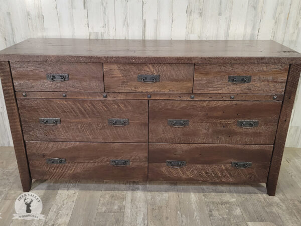 Authentic barnwood dresser with an American walnut stain, large top, four wide drawers stacked below three shallower drawers with black handles and an antiqued blackened clavos.