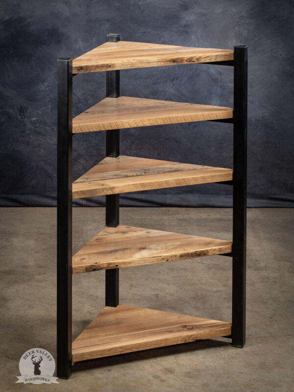 Rustic free standing corner shelf with five reclaimed barnwood shelves and antique blackened welded steel vertical uprights.