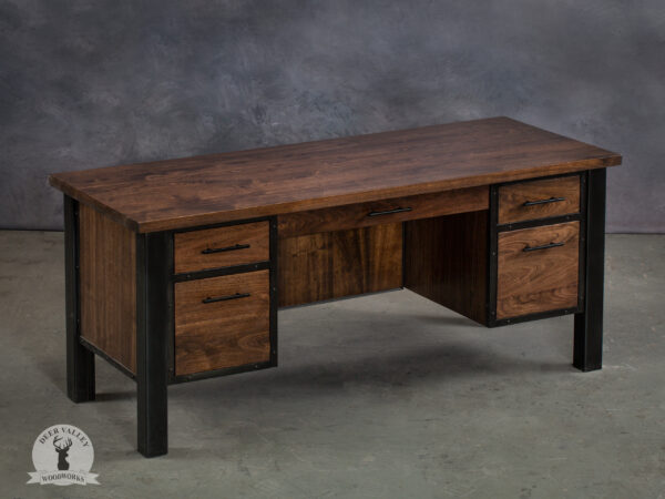 Solid black walnut executive desk with lustrous dark walnut stain, five drawers, hidden power hub, modesty panels and blackened welded steel frame.