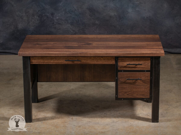 Classic black walnut executive's desk with a large solid walnut desktop, pencil drawer, storage drawer, file drawer, modesty panels, and blackened industrial welded steel legs and framework.