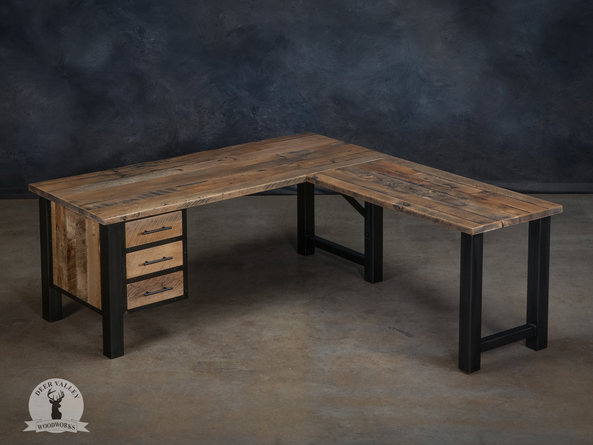 Rustic barnwood corner desk, handcrafted with a spacious desktop, bank of three drawers and blackened welded steel frame.