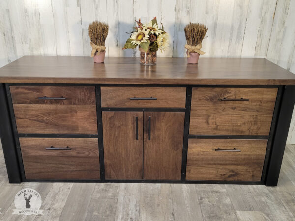 Modern black walnut office credenza with a dark walnut stain, large countertop, four deep file drawers, a center storage drawer, pair of book matched walnut doors and antiqued blackened welded steel frame and legs.