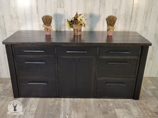 Authentic reclaimed barnwood credenza with a black ebonized finish, with a large barnwood countertop, four deep file drawers, three storage drawers, a pair of barnwood door and blackened welded steel frame and legs.