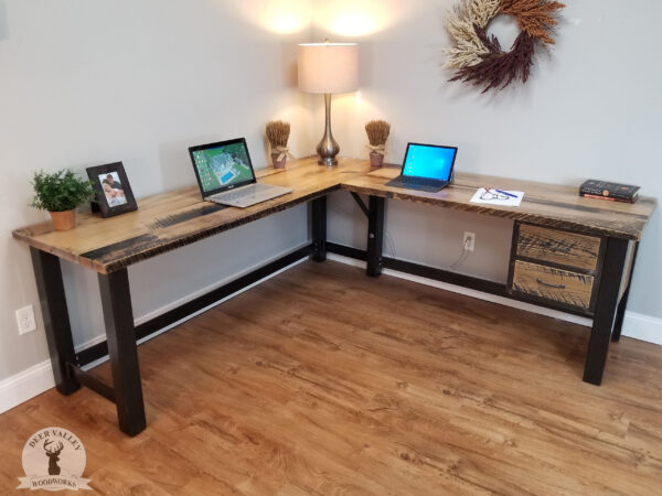 Barnwood corner desk with large, reclaimed wood desktop, twin framed drawers and blackened welded steel legs and an industrial welded framework.