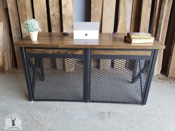 Industrial writing desk with a walnut stained hardwood desktop, two pencil drawers, blackened welded steel tubing frame with a steel mesh panel in the front.