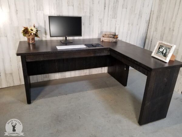 Modern barnwood corner desk with an ebonized finish, large desktop, privacy panels, lap drawer and matching barnwood leg panels.
