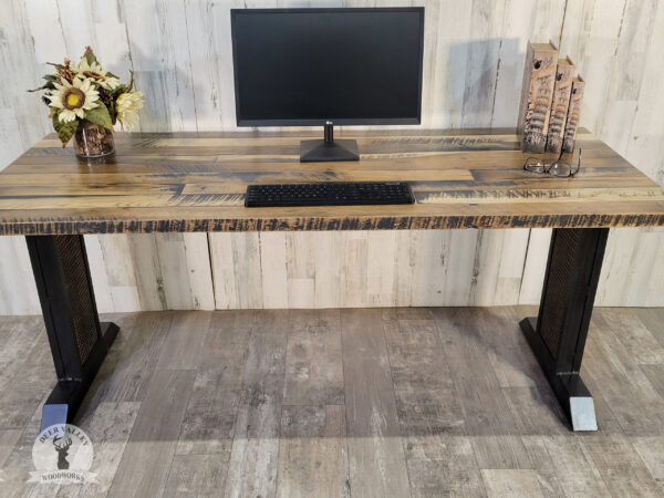 Industrial barnwood straight desk with a long barnwood desktop with blackened welded steel legs with a metal mesh overlay.