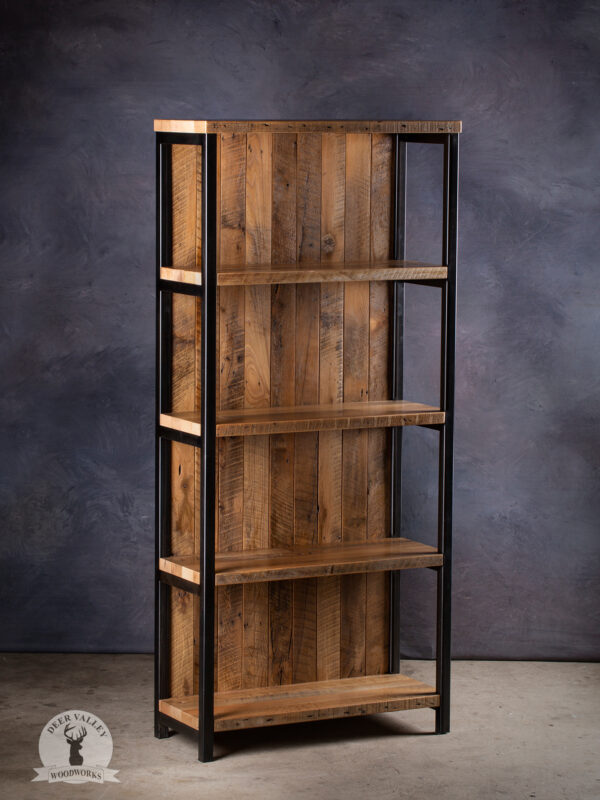 Industrial free-standing bookshelf with five reclaimed barnwood shelves with a barnwood backing and blackened welded steel vertical uprights.