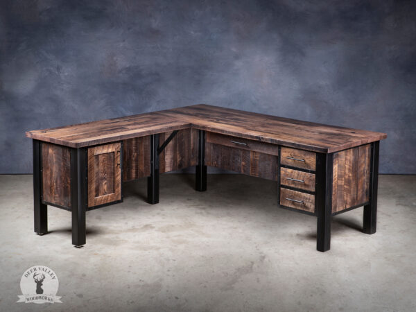 Rustic mahogany stained barnwood corner desk with a large desktop, three framed drawers, cabinet storage with an industrial blackened welded framework connected by barnwood modesty panels around the full perimeter.