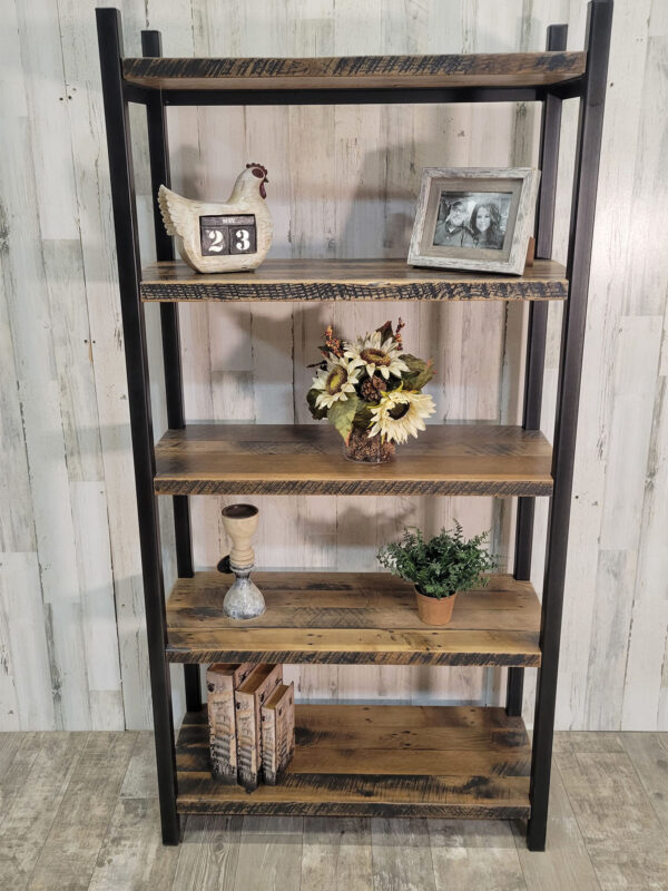 Industrial free-standing bookshelf with five heavy duty reclaimed barnwood shelves and vertical uprights made from steel with an antique blackened finish and fully welded shelf supports.