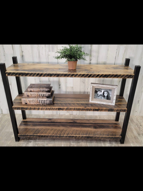 Handmade free-standing bookshelf with three heavy duty reclaimed barnwood shelves and antique blackened patina vertical uprights.