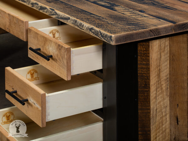Closeup view of the open bank of three drawers and pencil drawer in our rustic barnwood corner desk, highlighting its sturdy construction and beautiful characteristics of the barnwood.