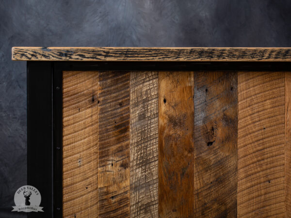 Closeup view of the barnwood and blackened welded steel frame in our rustic barnwood corner desk, showing beautiful characteristics of the barnwood.