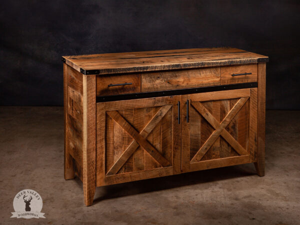 Rustic barnwood vanity with a thick barnwood top, two drawers, two large barnwood doors with recessed center panels and an antiqued blackened metal strap on the face and outside corner brackets.