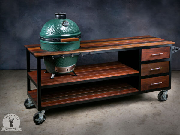 Unique grill cart handmade from exotic Ipe hardwood and solar black welded steel with two large shelves, stainless steel hooks, three stainless steel drawers with Ipe fronts, and swivel casters.