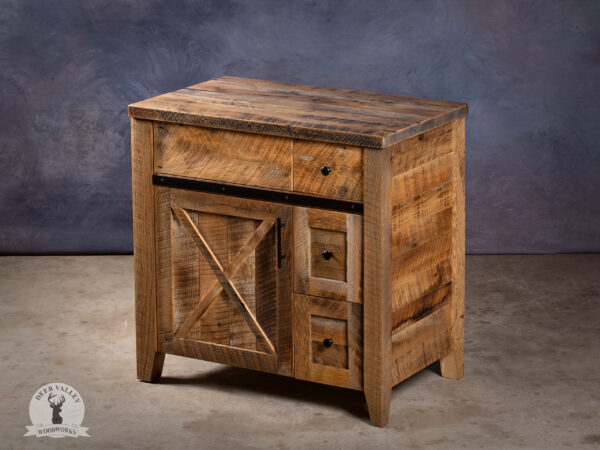 Rustic single sink barnwood vanity with countertop, three drawers and cabinet doors with recessed center panels.