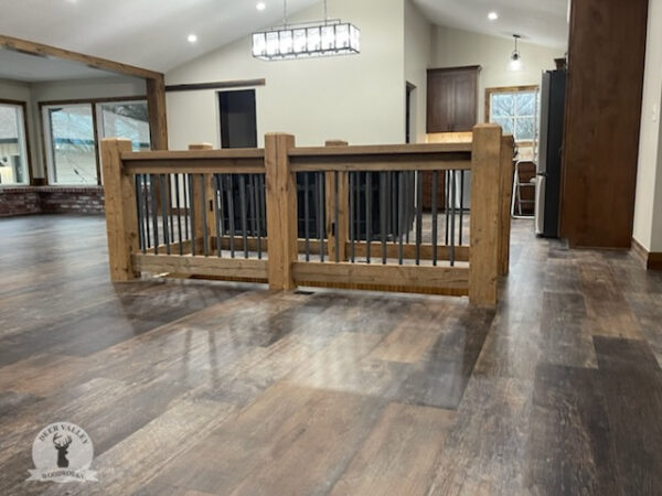 Rustic reclaimed railings handcrafted with authentic reclaimed unfinished barn beams with blackened rebar balusters.