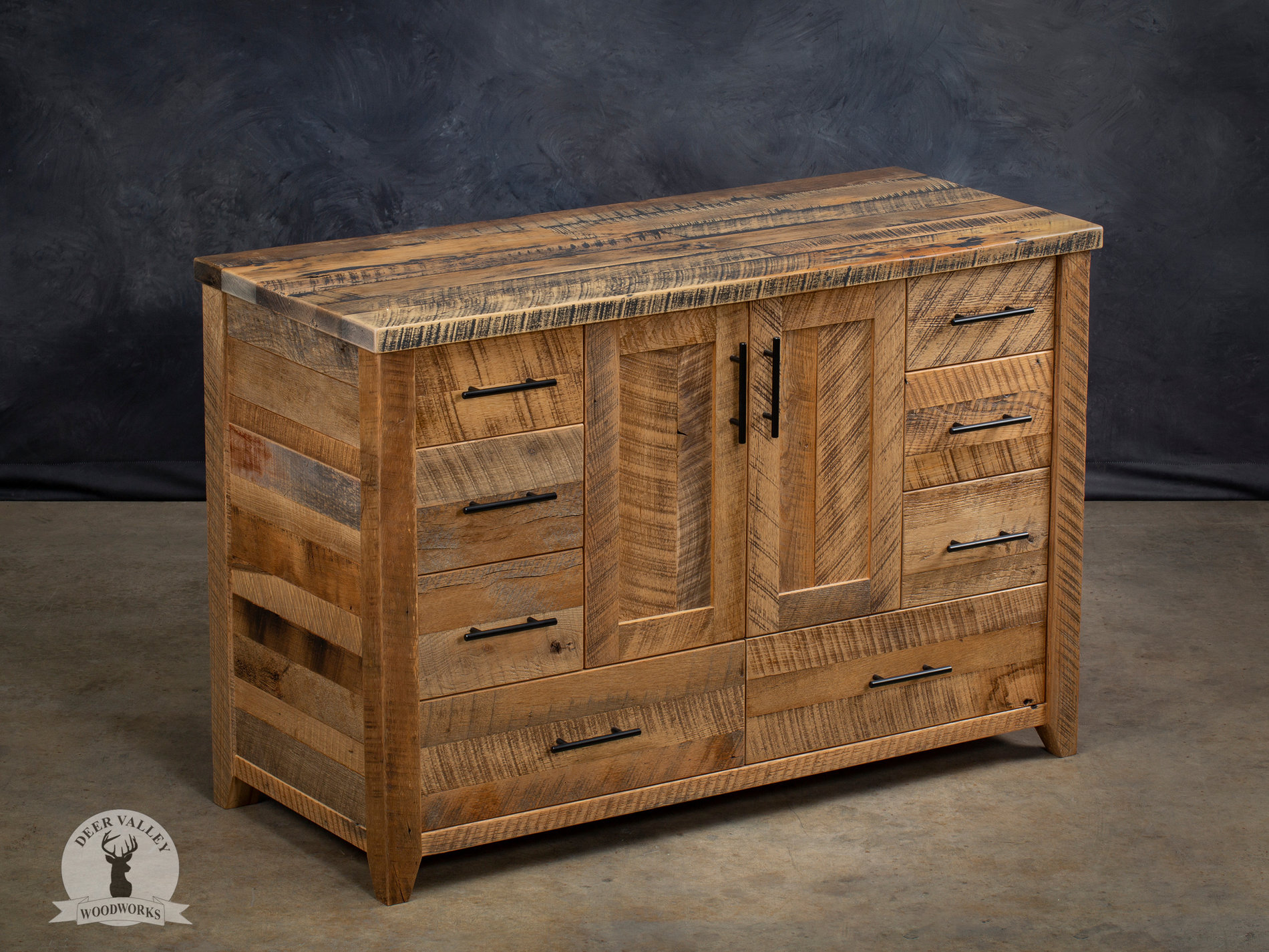 Barnwood farmhouse vanity with a large top, bank of four drawers on each side and center doors with recessed center panels.